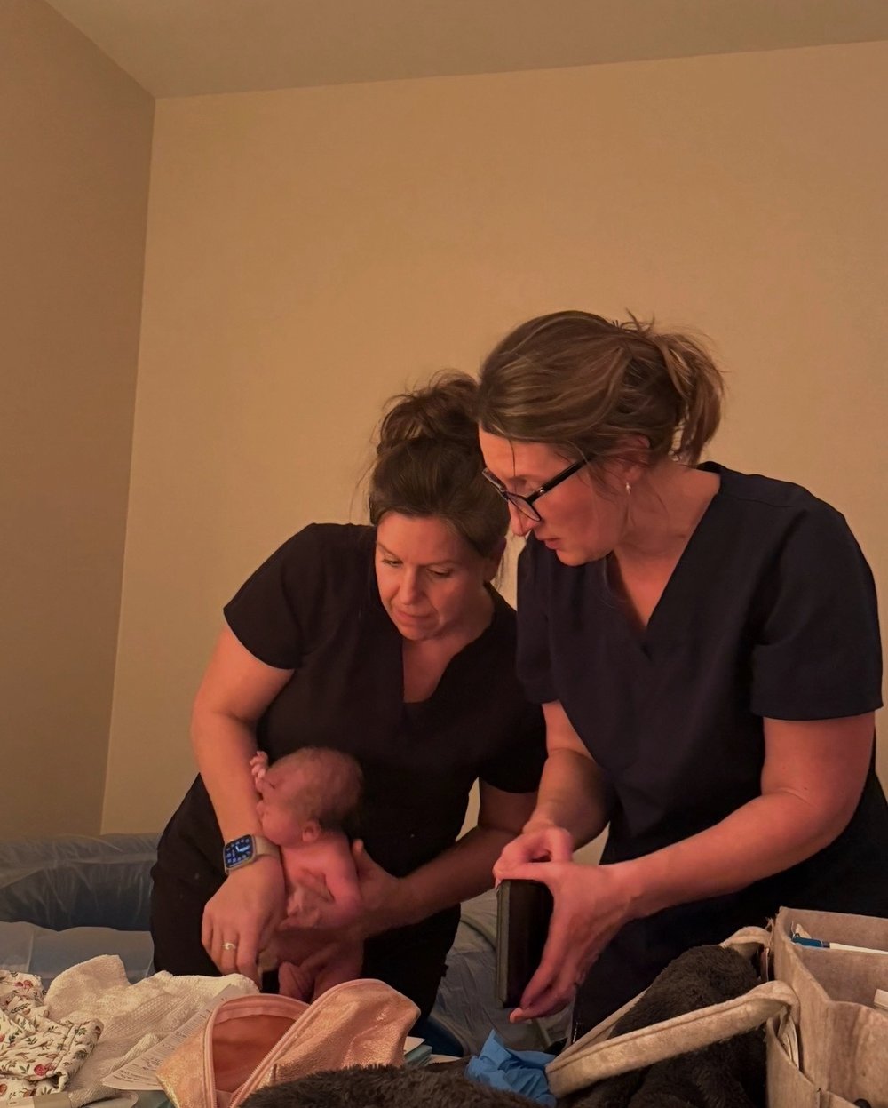 Our midwives caring for a newborn beside the birth tub