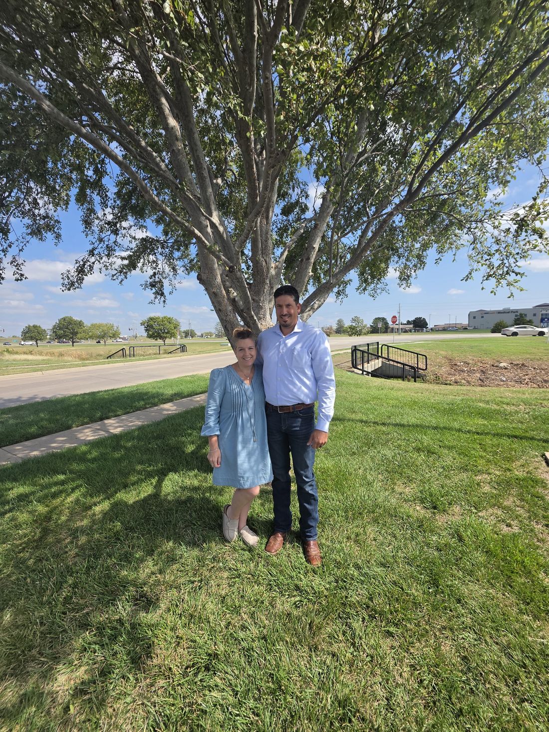 Sarah and her husband beneath the big shade tree